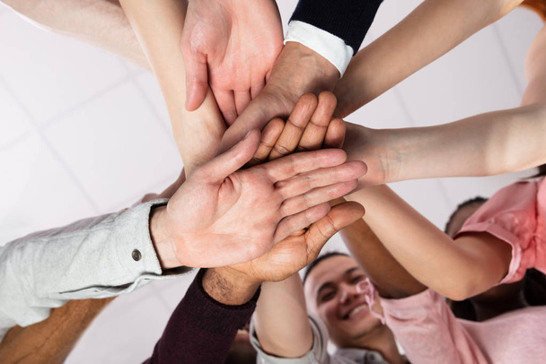 Multi-ethnic Group Of People Stacking Hand Showing Unity - Foto, Imagen