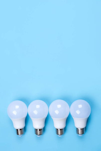Several LED bulb on blue background. Saving energy concept. - Foto, afbeelding