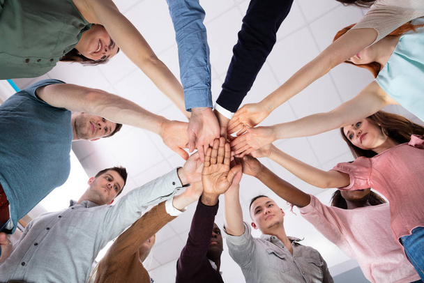 Multi-ethnic Group Of People Stacking Hand Showing Unity - 写真・画像