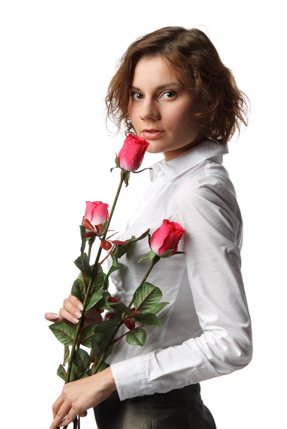The beautiful girl with a bouquet of roses on a white background. - Photo, image