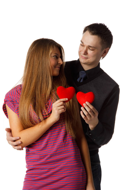 Young enamoured couple with a heart on a white background. - Foto, Bild