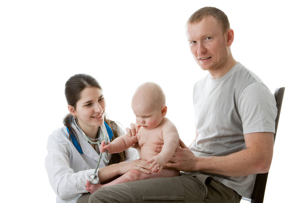 The female doctor with a stethoscope and the daddy with the small child on a white background. - Photo, Image