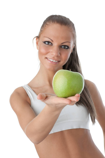 Young beautiful girl with apple in hands on a white background. Healthy food concept - Photo, Image