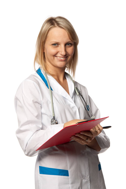 Smiling medical doctor with stethoscope and clipboard on a  white background. Medical concept. - Fotó, kép