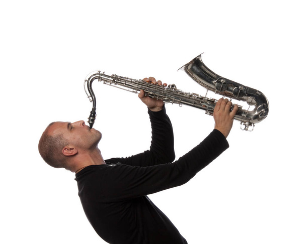 Man with saxophone on a white background - Valokuva, kuva