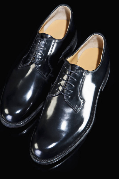 elegant black leather shoes on a dark background - Фото, изображение