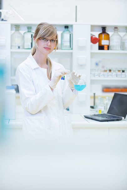 female researcher carrying out experiments in a chemistry lab (color toned image) - Zdjęcie, obraz