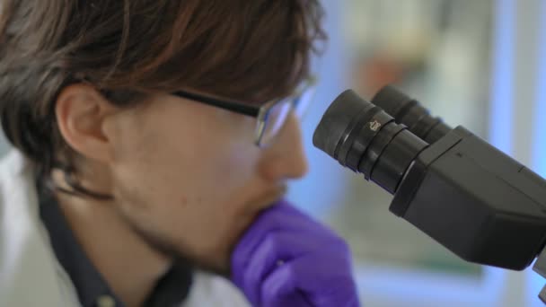 Pensive or concerned scientist in a laboratory. Closeup shot - Felvétel, videó