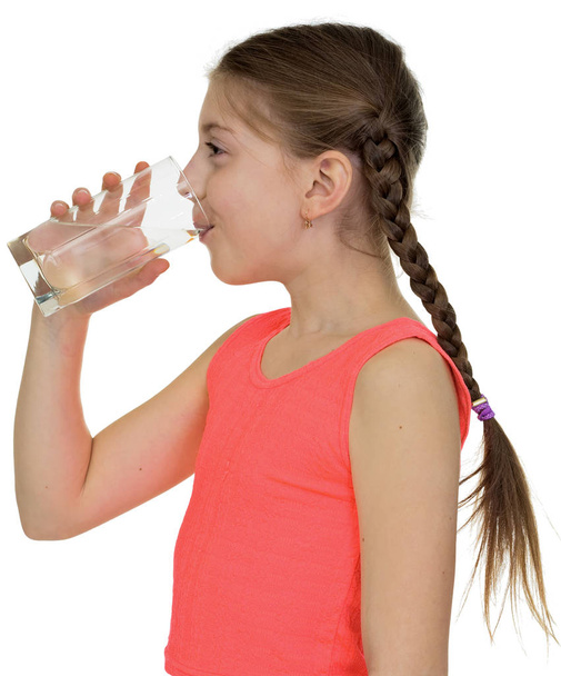 Girl drinks potable water from a glass - Фото, изображение