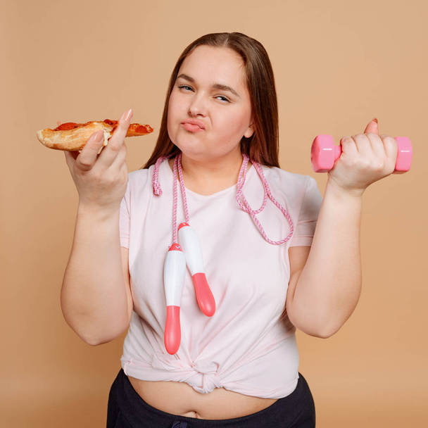 Overgewicht vrouw worstelt met overeten. Fitness en dieetconcept - Foto, afbeelding