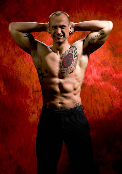 muscular man with naked torso posing in studio - Zdjęcie, obraz