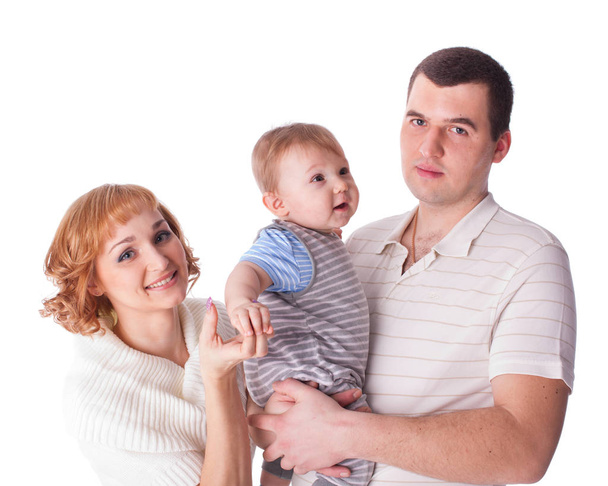 Young parents with their sweet  baby on a white background. Happy family. - Foto, Imagen