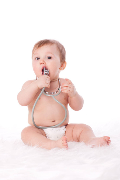 Sweet baby with stethoscope on a  white background. - Foto, Imagen
