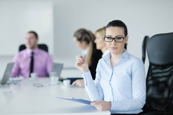 Successful business woman standing with her staff in background at modern bright office - Фото, зображення