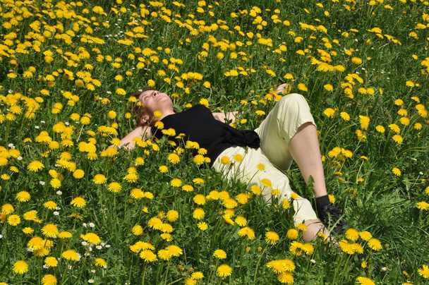 young woman on dandelion meadow - Zdjęcie, obraz