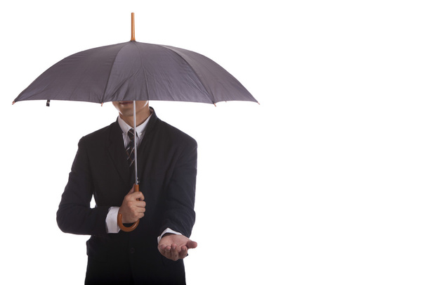 Businessman standing under a black umbrella - Zdjęcie, obraz