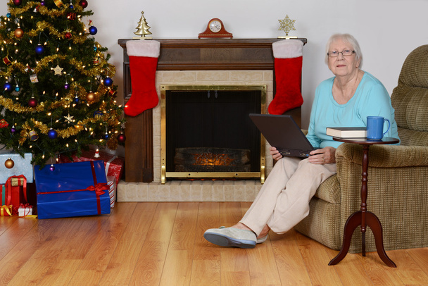 Happy senior with laptop at christmas - Foto, imagen