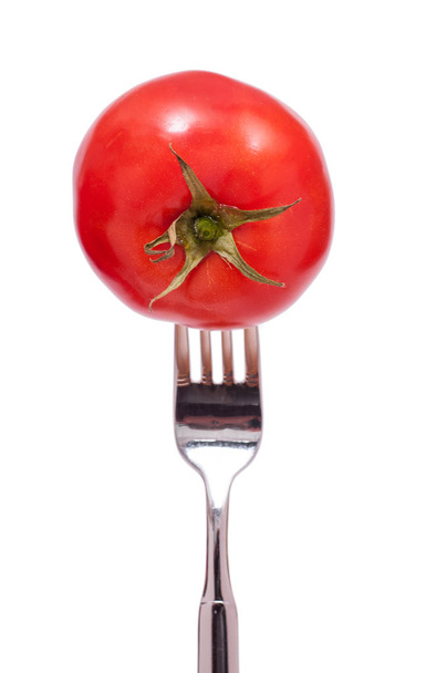 impaled a red tomato with tomatoes on a fork green - Fotoğraf, Görsel