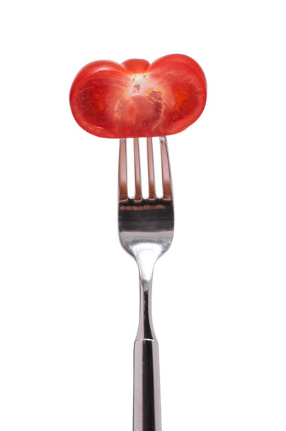 a fork with a half red tomato - Photo, Image