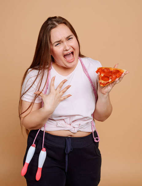 Overweight woman crying because she wants pizza - 写真・画像