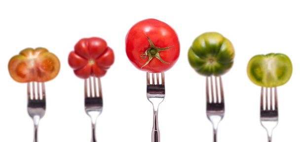 five red and green tomatoes with fork - Foto, imagen