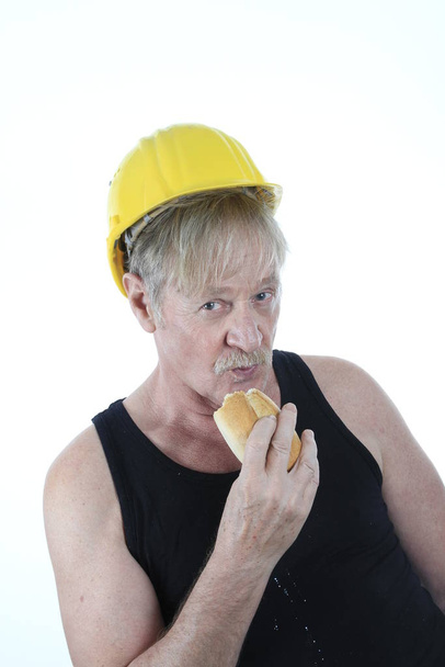construction worker eating a bun - Fotó, kép