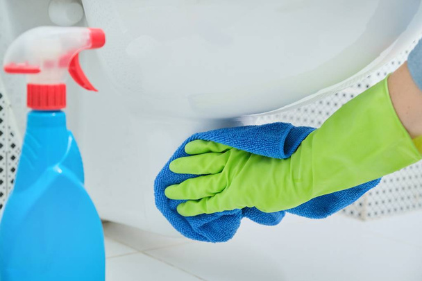 Close-up of hand in gloves with rag and detergent washing hanging toilet - Foto, Imagen