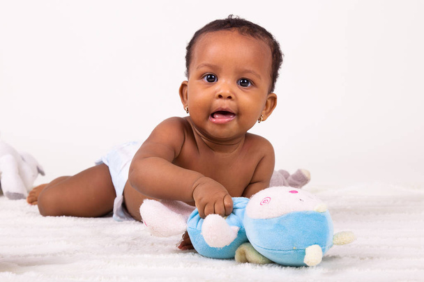 Adorable little african american baby girl  lying down - Foto, immagini
