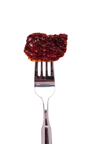 white cropped red dried tomato on a fork - Fotografie, Obrázek