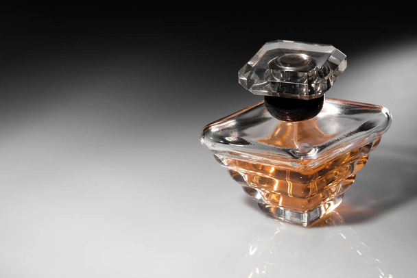 Perfume in a stylish glass jar on abstract background - Fotoğraf, Görsel
