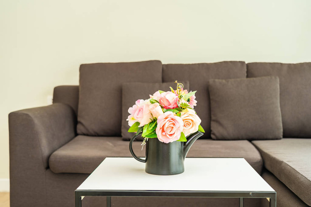 Vase flower on table with pillow and sofa decoration interior - Photo, Image