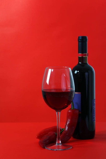Red wine and glass with red background - Valokuva, kuva