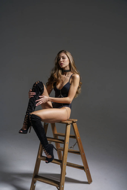 Beautiful girl sexy blonde in underwear and boots posing on studio background - Фото, зображення