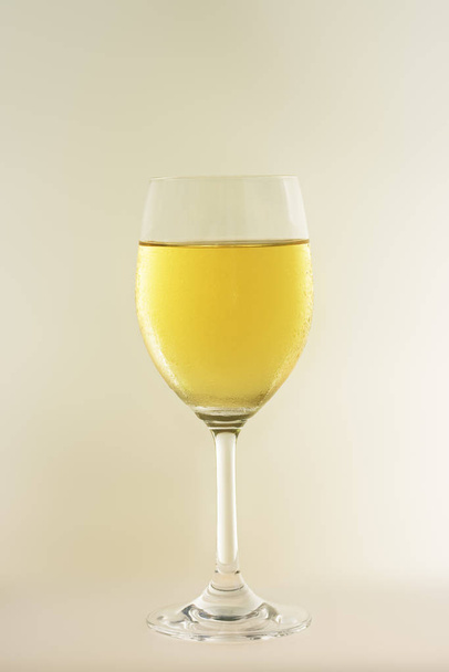Glass of white whine on abstract background - 写真・画像