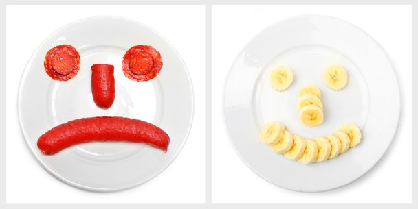 Collage of two emoticons from food on a plate. - Photo, Image
