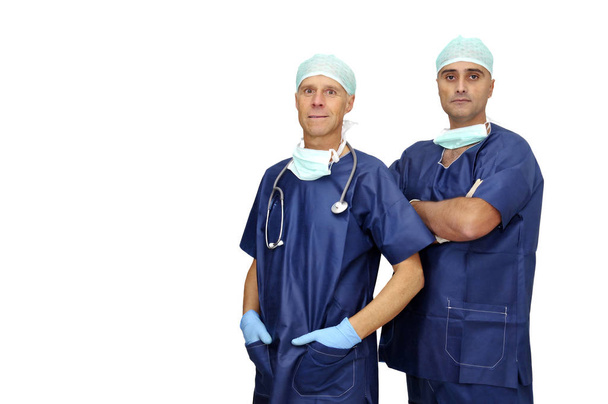 Doctors team in uniform posing isolated in white - Фото, изображение