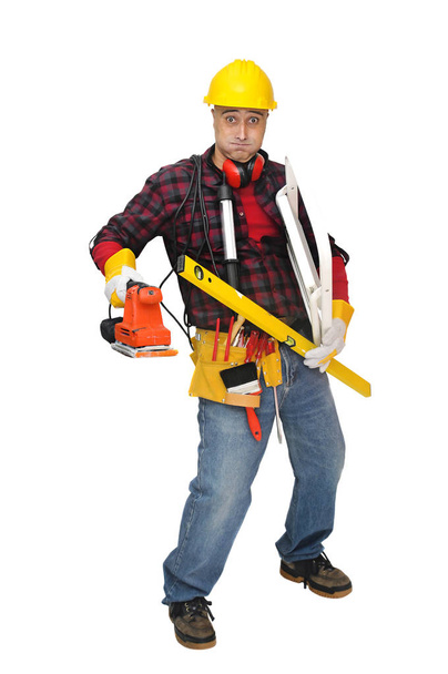 Stressed construction worker with lots of tools isolated in white - Photo, image