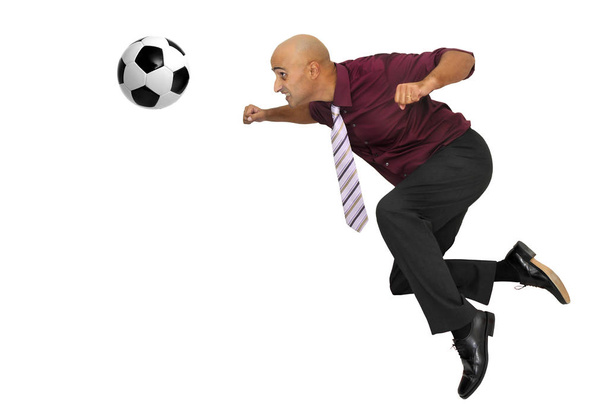 Empresario en pose acrobática con balón de fútbol aislado en blanco
 - Foto, Imagen