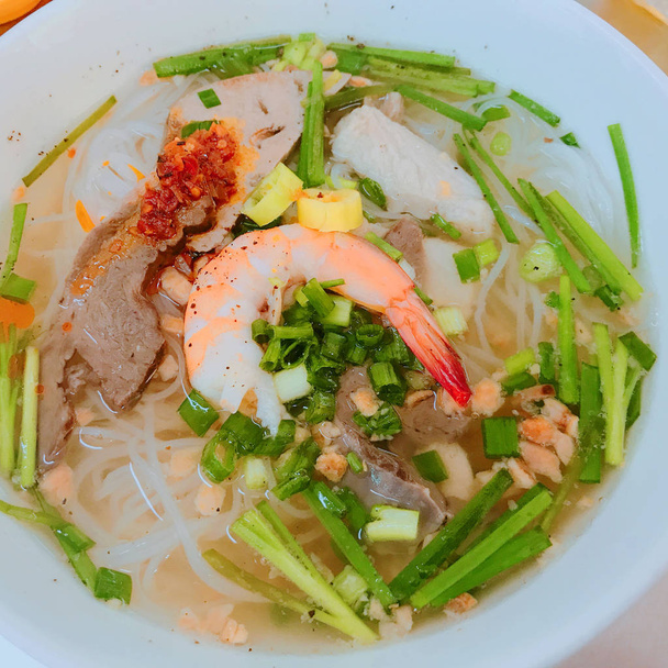 Hu Tieu Nam Vang Pho bo Vietnamese noodles soup with pork beef sprawn traditional food beef chicken broth herbs chili sauce fresh chili spring  - Photo, Image
