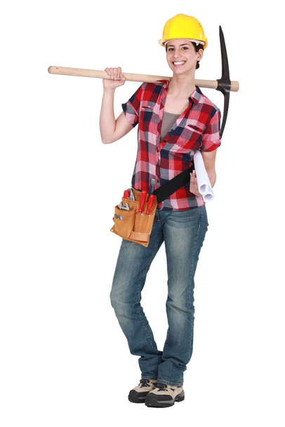 Woman holding pick-axe - Foto, afbeelding