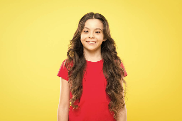 Little girl grow long hair. Teen fashion model. Styling curly hair. Change you can see. Hairdresser tip. Kid girl long healthy shiny hair. Perfect curls. Kid cute face with adorable curly hairstyle - Foto, afbeelding