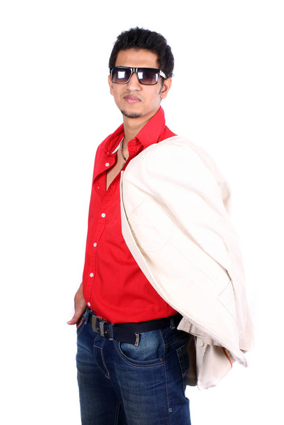 A smart young Indian guy wearing shades and a coat over his shoulders, on white studio background. - Foto, Imagem