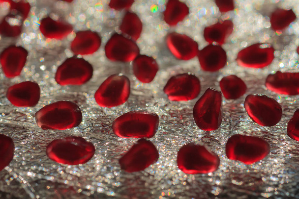 Pomegranate seeds on the sparkling crystal platter - Fotó, kép