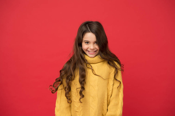 Styling curly hair. Hairdresser tip. Kid girl long healthy shiny hair. Natural curls. Long lasting effect. Kid cute face adorable curly hairstyle. Little girl grow long hair. Teen fashion model - Photo, image