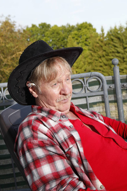 pensioner relaxing on a balcony - Fotó, kép