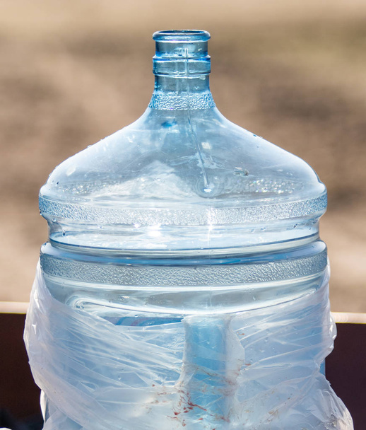 Μπουκαλάκι πλαστικό για 20 λίτρα νερό στο δρόμο. - Φωτογραφία, εικόνα