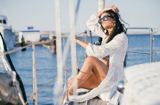 Beautiful woman posing on the yacht - 写真・画像