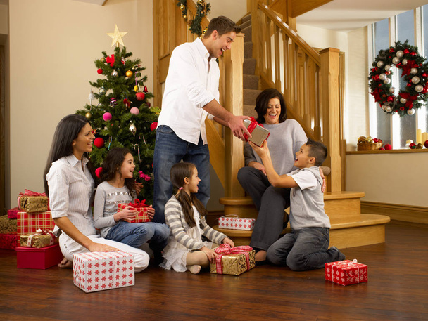 Hispanic family exchanging gifts at Christmas - Fotografie, Obrázek