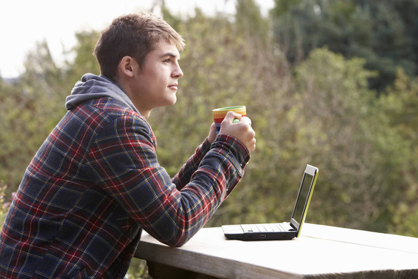 Young man with laptop computer - Foto, Imagen