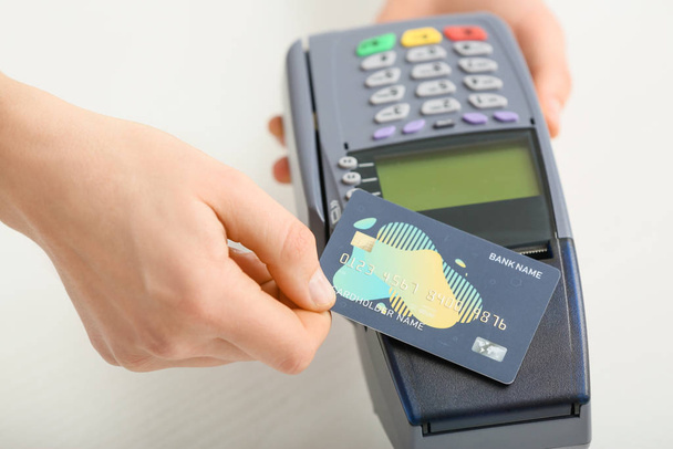 Mujer que usa terminal bancaria para pago con tarjeta de crédito, primer plano
 - Foto, imagen